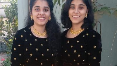 Twin sisters secure identical marks in II PU exam