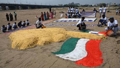 Students come up with sand sculpture on Cauvery bed for voter awareness