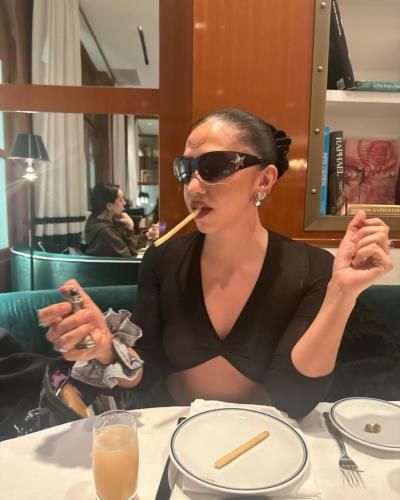 Rosalía Enjoying Food, Cigarettes, Drinks, And A Photoshoot