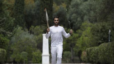 Despite weather glitch, Paris Olympics flame lit at the Greek cradle of ancient games