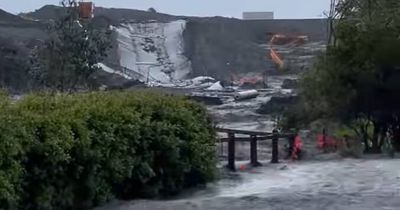 Private dam overflows at Catherine Hill Bay building site as Newcastle drenched in rain