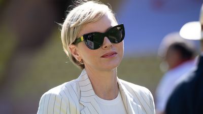 Princess Charlene's white pinstripe blazer looks so chic with her ultra blonde pixie cut and cat eye sunnies