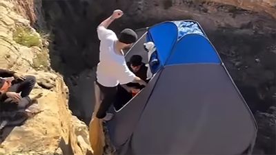How not to go camping this summer: men film themselves leaping into pop-up tent on cliff edge