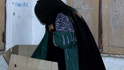 Women polling staff to verify the identities of veiled women