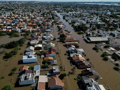 Brazilians Queue For Precious Water As Flood Damage Intensifies