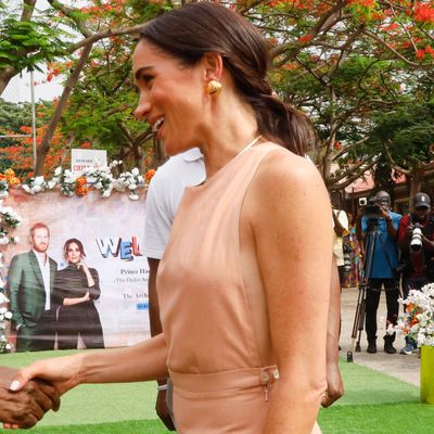 Meghan Markle Glows in a Sleeveless Peach Sundress for the First Day of Her Nigeria Visit