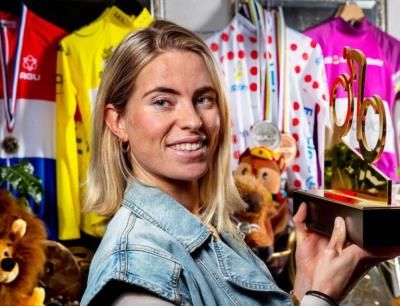 Demi Vollering: Champion Cyclist Celebrating Success With Trophy Display
