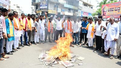 Posters of accused set on fire during protest against assault on used car seller in Kalaburagi