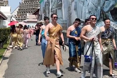 Men in costumes at temple start trend