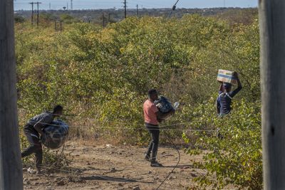 Anxious Zimbabwean migrants, smugglers watch South Africa’s election