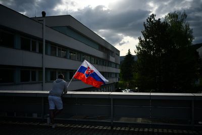 Suspect in shooting of Slovak prime minister is escorted to his home as police search for evidence