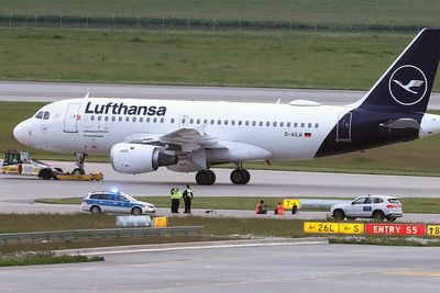 Climate activists glue themselves at Munich airport to protest pollution caused by flying