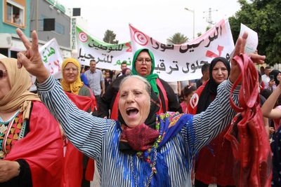 Tunisians stage anti-migrant protest as the number of stranded in transit to Europe grows