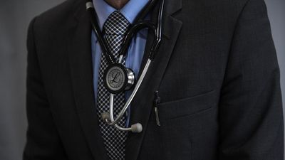 Doctor charged with indecently assaulting woman