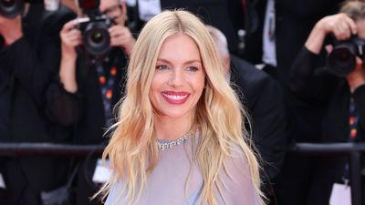 Sienna Miller is striking in barrel leg jeans and cream tweed jacket at the Cannes Film Festival