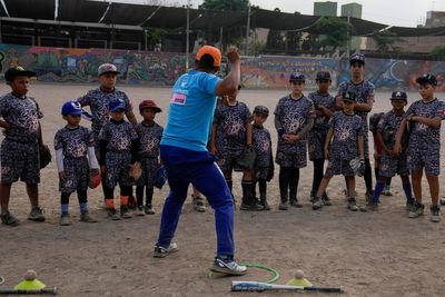 Baseball becomes a shelter for Venezuelan children in soccer-mad Peru