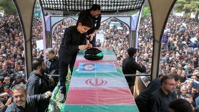 Tens of thousands in Iran march to mourn Raisi as late president laid to rest in home town