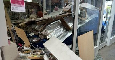 Two narrowly escape harm after car smashes into shop