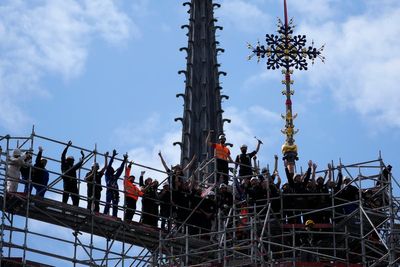 Notre Dame cathedral cross reinstalled in Paris amid restoration efforts