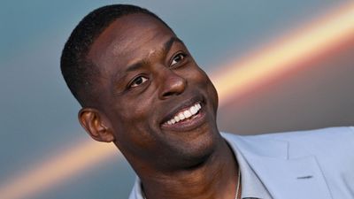 Sterling K. Brown's bedroom takes on the unexpected red trend with bold, contrasting throw pillows