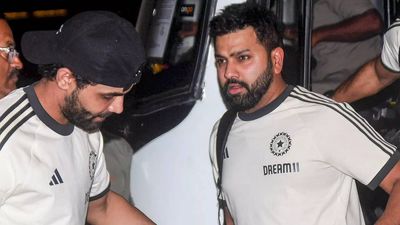 Rohit Sharma fulfills a fan's special request despite standing at airport security check - WATCH