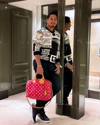 Carlos Carrasco: Fashionable And Confident Pose With Stylish Pink Bag