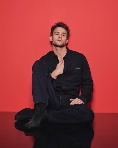 Brandon Flynn Stuns In Bold Photoshoot With Striking Backdrop