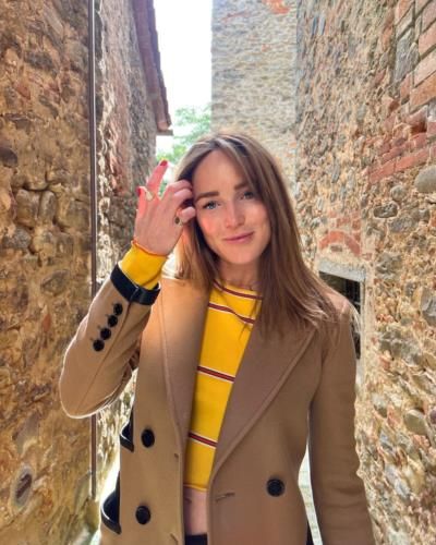 Caity Lotz Radiates Style In Yellow Shirt And Brown Coat