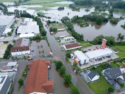 A firefighter dies and a long-distance train derails amid heavy rains and flooding in Germany