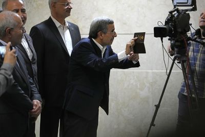 Iran’s ex-president Ahmadinejad, disqualified Larijani sign up for election