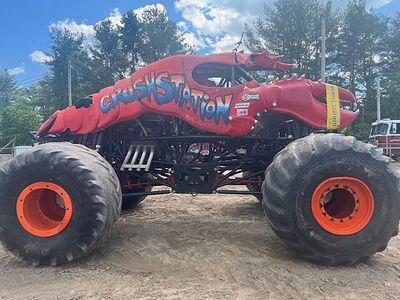 Monster truck clips aerial power line, toppling utility poles in spectator area