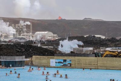 Tourists watch volcano erupt from spa as popular Iceland attraction reopens