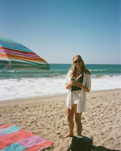 Brianne Howey Enjoys Beach Day With Beloved Pet Dog