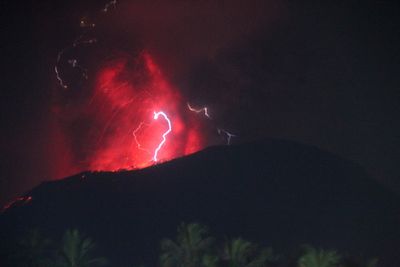 Indonesia’s Mount Ibu erupts 3 times, spewing lava and clouds of grey ash