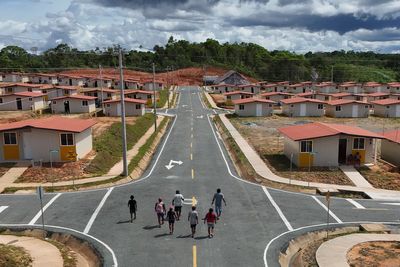 Panama community pushed from Caribbean island by rising sea levels moves into new houses