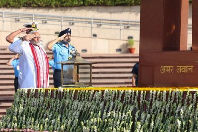 PM-elect Narendra Modi signs visitor's book after laying wreath at the National War Memorial