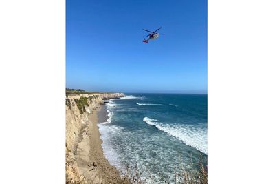 Kite surfer rescued from remote California beach rescued after making 'HELP' sign with rocks