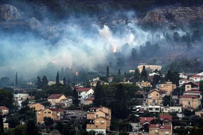 Hezbollah fires 200 rockets at Israel after senior commander killed