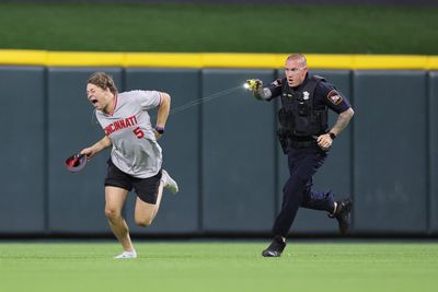 The photos of a fan who did a backflip and got Tased invading the Reds’ field are wild