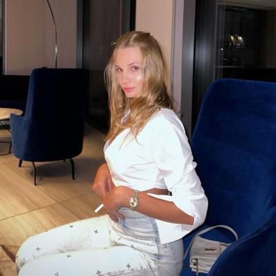 Elegant Relaxation: Dayana Yastremska's White Sofa Pose