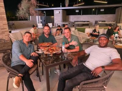 Baseball Teammates Bond Over Lunch In Vibrant Restaurant Setting