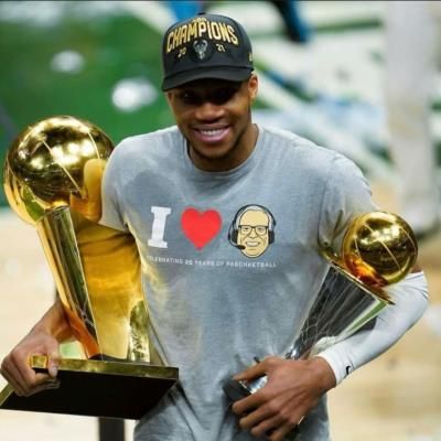 Giannis Antetokounmpo Celebrates Victories With Two Basketball Trophies