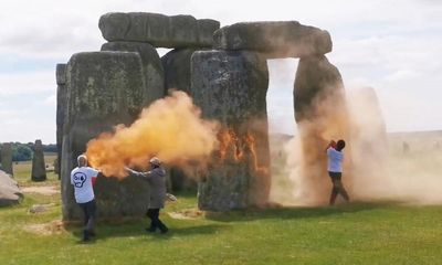 Stonehenge sprayed with orange powder paint by Just Stop Oil activists