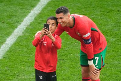 Four fans get on field for selfies with Cristiano Ronaldo during chaotic scenes at Euro 2024 match