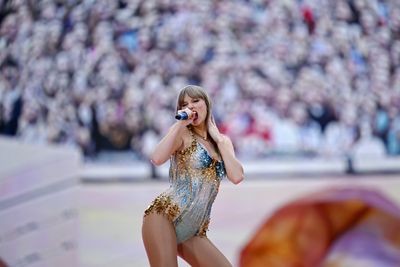 Taylor Swift blew Travis Kelce a flirty kiss after his Eras Tour debut on stage, and it was adorable