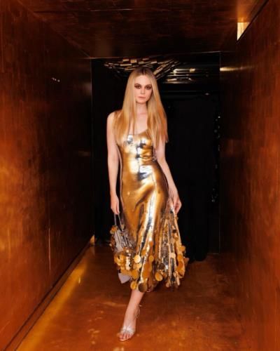 Elle Fanning Radiates Elegance In Stunning Gold Dress Pose