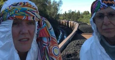 Three protest stunts in one day: two women perform song and dance on coal train