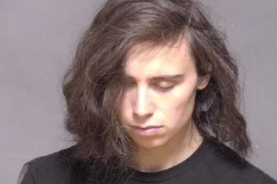 Driver arrested as police at scene of car crash find dead body in the back of her car