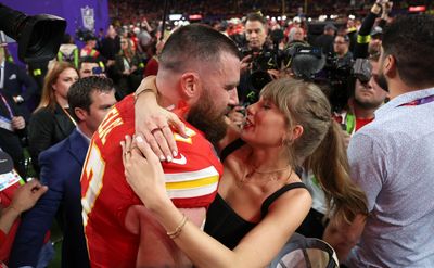 A photo of Travis Kelce carrying Taylor Swift has become a perfect meme