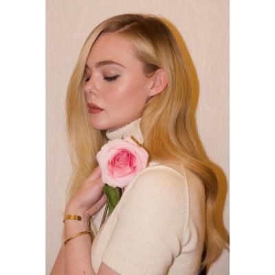 Elle Fanning Stuns In Vibrant Photoshoot With Pink Flower